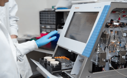 Lab technician behind screen